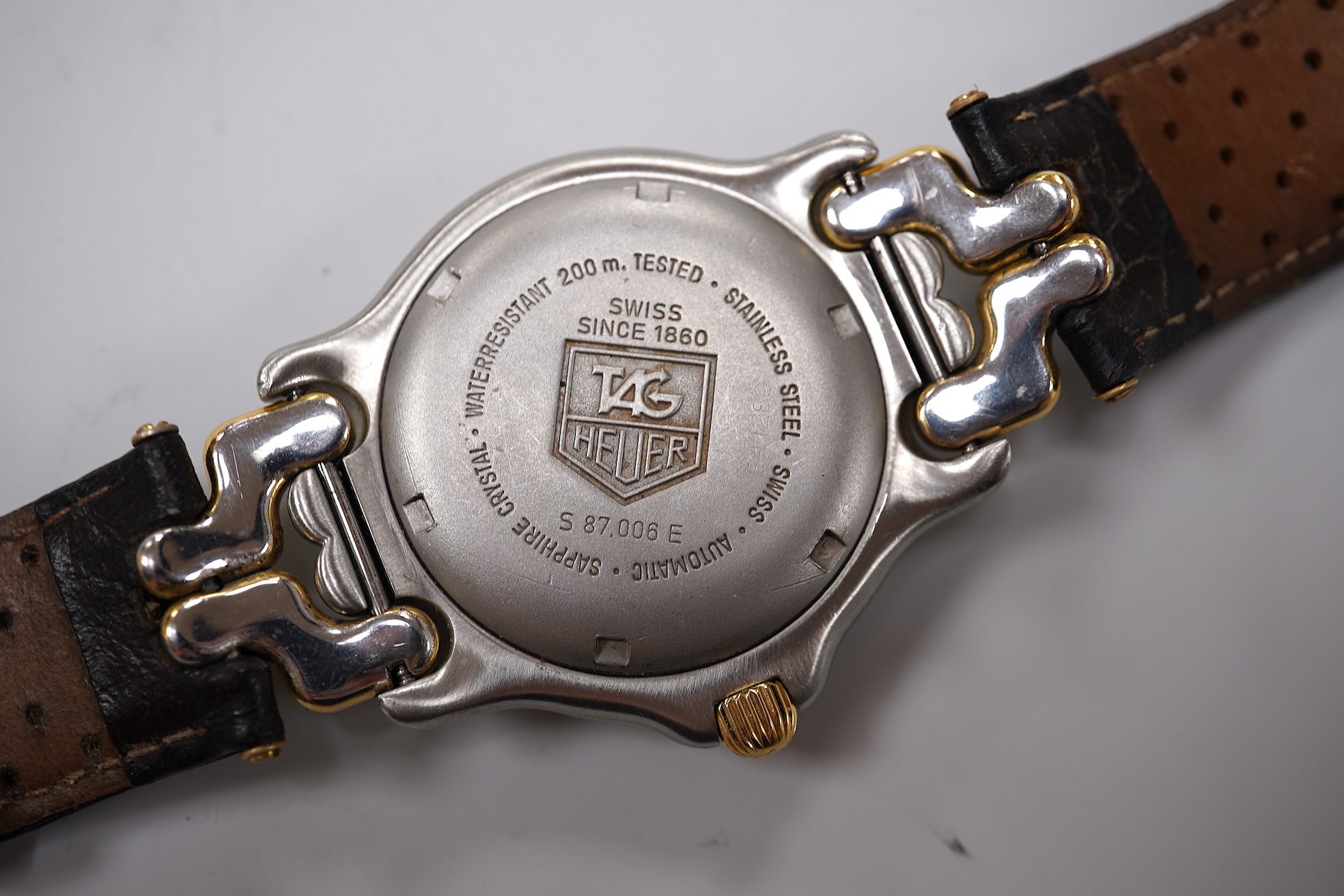 A gentleman's recent stainless steel and gold plated Tag Heuer automatic wrist watch, on an associated leather strap, case diameter 38mm, with Tag box and 2023 service guarantee card.